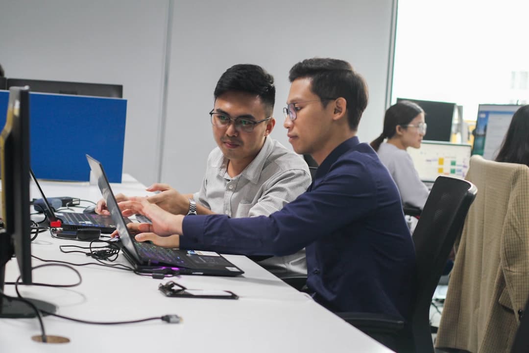 Analysts reviewing a data catalog dashboard on a laptop in an office setting.