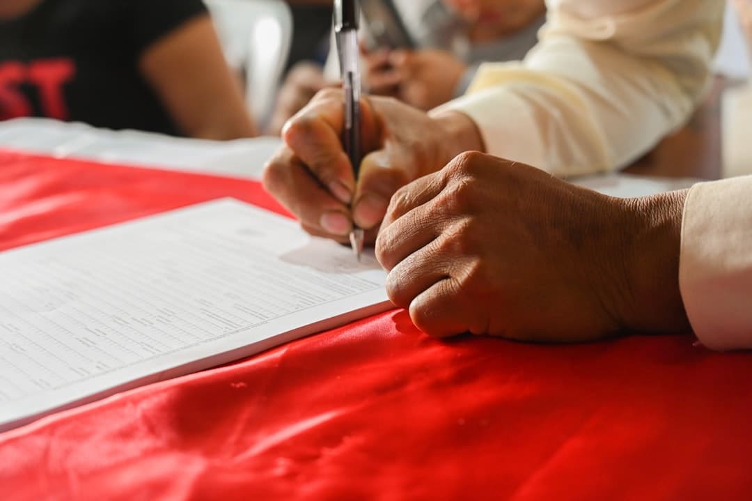 Government procurement and legal staff reviewing a contract document with clause highlights.