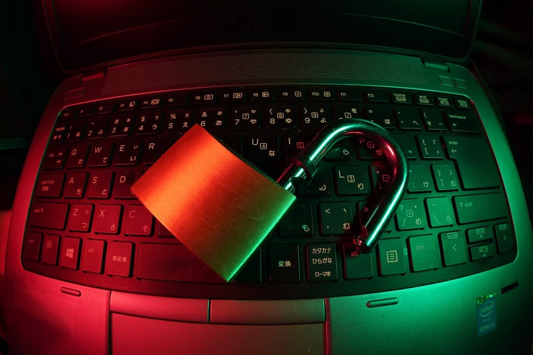 Digital padlock graphic displayed on a laptop screen with blurred server racks in the background.